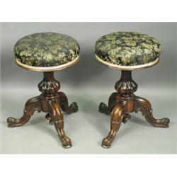 A pair of Victorian carved rosewood piano stools with revolving seats Est. 200/400...