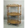 Image 1 : A Victorian walnut whatnot, with three shaped tiers, each backed with a pierced gallery, on tu...