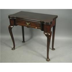 A George I mahogany tea table with rounded corners, a drawer and a vertically veneered frieze,...