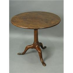 A George III mahogany tripod table, with a single piece circular top, and a birdcage action, o...