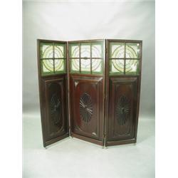 An Edwardian three fold dressing screen, the upper sections glazed with beadwork and brass ova...