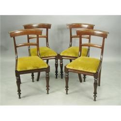 A set of four early Victorian mahogany bar back dining chairs with yellow drop in seats on tur...