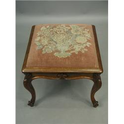 A Victorian square rosewood stool, the seat upholstered with a vase of flowers tapestry panel,...