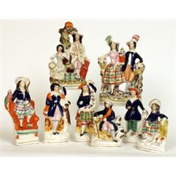 A pair of Staffordshire pottery figures, circa 1870, the lady and gentleman in cobalt blue jacket...