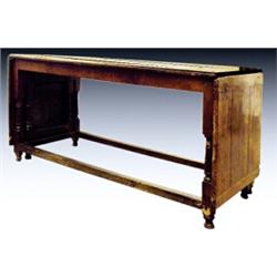 An 18th Century planked oak dining table, of rectangular form with twin end hinged gateleg flaps,...