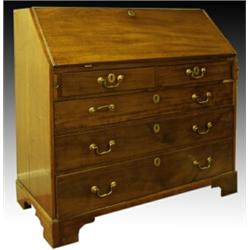 A George III mahogany and oak bureau, circa 1785, the hinged fall front opening to reveal a stain...