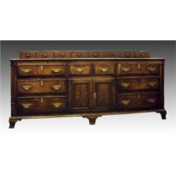 A George III oak and mahogany crossbanded dresser, circa 1780, the planked and moulded rectangula...