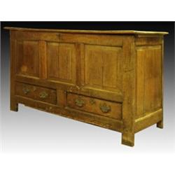 A George III oak mule chest, circa 1780, the hinged planked top above a three panelled front and...