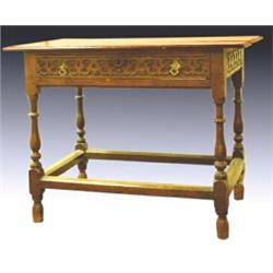 An early 18th Century oak side table, the planked rectangular top above a carved single drawer wi...