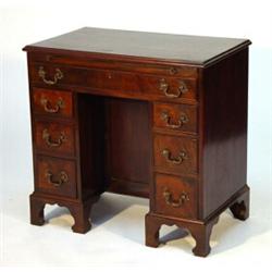 George III design mahogany kneehole desk, fitted a brushing slide above a long drawer and centre…