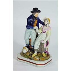 Early hand painted Staffordshire figure group of a gentleman and seated lady, 25cm high…