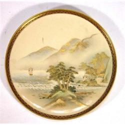 Circular Japanese Satsuma plate, hand painted and gilded with a coastline scene beneath mountains…