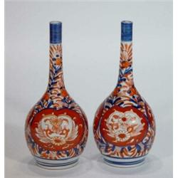 Pair of hand painted Japanese Imari bottle vases, decorated with panels of flowers, 20cm high…