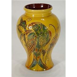 Brannam Barnstable yellow glazed vase, decorated with a blue and brown parrot amongst foliage, im…