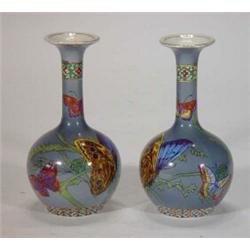 Pair of early Maling Cetemware bottle vases, hand painted and transfer printed with butterflies o…