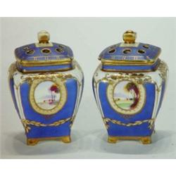 Pair of Noritake vases and covers with pierced lids, hand painted with panels of flowers and land…