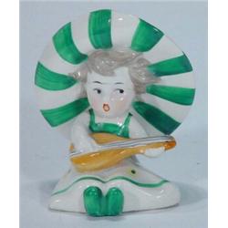 Hand painted Goebels seated girl playing a mandolin wearing a green striped hat, impressed marks…