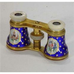 Pair of brass and mother-of-pearl opera glasses, enamelled with panels of flowers onto a gilt and…