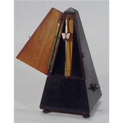 Ebonised Maelzel metronome on bun feet, 23cm high…