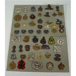 Three sheets of assorted military badges including Kings Own Regiment, Medical Corps, United Serv…