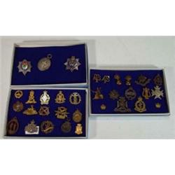 Approximately 25 military badges including Tank Corps, Worcester, Wiltshire Regiments, etc…