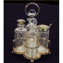 Silver plated and cut glass four bottle cruet set, 23cm high…