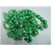 Image 1 : Two light green jade necklaces…