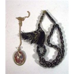 String of inlaid worry beads and a cameo style necklace…