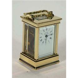 Sainte Juxanne, France, brass carriage clock with bevelled glass panels and swing handle, 16cm hi…