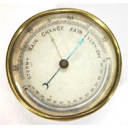 Circular brass cased aneroid barometer with bevelled glass face, 12cm diameter…