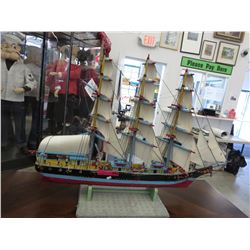 Hand crafted wood boat on stand