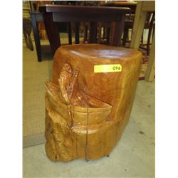 Cedar chainsaw carving of a Man in a Canoe