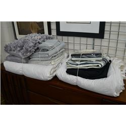 Selection of show home linens including comforter, duvet and sheet sets, throw pillows etc.