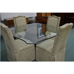 Modern dining suite including glass topped table with wooden center base and four fully upholstered 