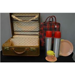 Vintage suitcase and a Thermos brand picnic including two thermos', two plates and two tea cups and 