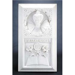 A marble plaque, carved with a bust of Elizabeth I in relief above roses, lilies and a book, bear...