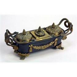 A bronze and gilt bronze inkwell in Empire style of sarcophagus shape with serpent handles, three...