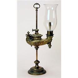 A late 19th century Continental brass adjustable table lamp and shade in the form of a colze type...