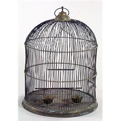 An early 20th century brass bird cage of domed form, with wirework slats, a perch, a door and a r...