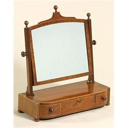 A George IV mahogany dressing table mirror, the crossbanded arched frame flanked by reeded suppor...