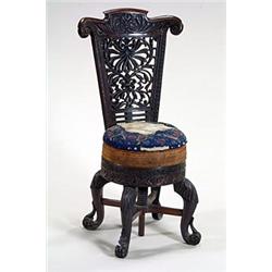 A 19th century colonial hardwood music chair, the back pierced and carved overall, with a padded...