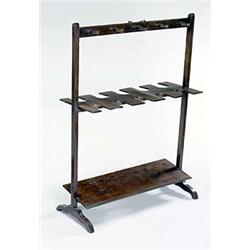 An early 19th century mahogany boot and whip rack with a brass handle on downswept feet, 92 high...