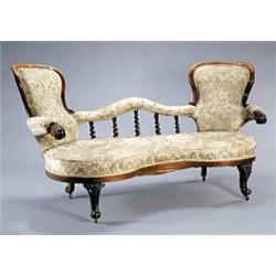 An early Victorian rosewood show-frame sofa, with two rounded ends, a low back with spirally flut...