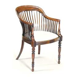 A late Victorian mahogany tub shaped elbow chair with slatted sides, a drop-in seat and turned le...