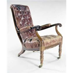 A William IV mahogany library chair with red leather buttoned back, arms and seat, on turned legs...