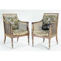 A pair of George IV mahogany library chairs each with a moulded rectangular back, caned sides, ba...