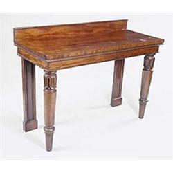 A William IV mahogany serving table with a raised back and plain frieze on turned legs carved wit...