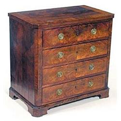 An early 19th century Continental mahogany chest, with canted corners, the crossbanded top above...