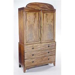 An early 19th century mahogany and ebony strung clothes press, the arched cornice and panelled do...