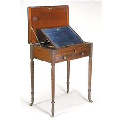 A George IV rosewood writing table, the brass strung rectangular top hinged to enclose a cedar li...